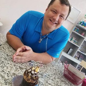 Travis with birthday cupcake