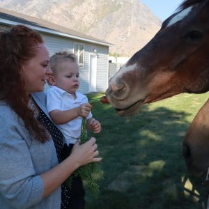 Jessica and Ryker feeding Grandpas horses